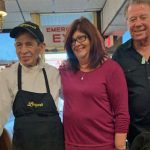 man in Langer's uniform posing for picture with daughter and Norm